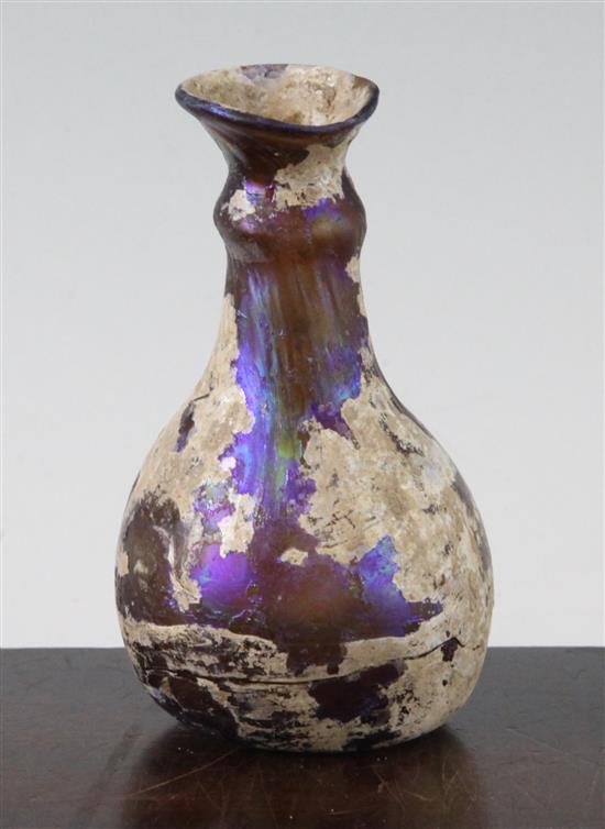 A Roman amber glass flask, c.2nd century AD, 11cm